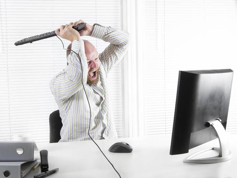 Man Smashing computer with keyboard